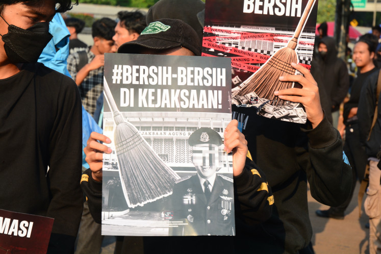 Protesters from a coalition of university students hold a banner reading &ldquo;Clean Up the Attorney General's Office&ldquo; during a demonstration outside the House of Representatives complex in Jakarta on July 10, 2026. The protesters called for an investigation into alleged corruption within the Attorney General's Office.