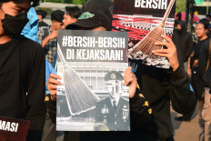 Protesters from a coalition of university students hold a banner reading &ldquo;Clean Up the Attorney General's Office&ldquo; during a demonstration outside the House of Representatives complex in Jakarta on July 10, 2026. The protesters called for an investigation into alleged corruption within the Attorney General's Office.