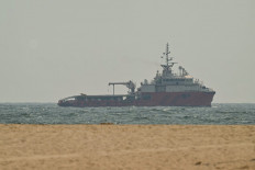 A ship sails off the coast of Ajman on July 10, 2026.