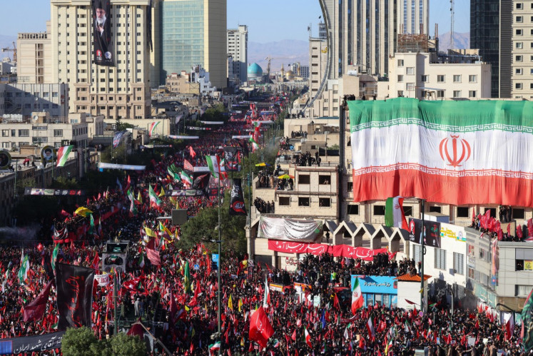 Crowds of mourners surround the convoy carrying the coffins of Iran's slain supreme leader Ali Khamenei and members of his family during a funeral procession before he is buried at the Shrine of Imam Reza, Iran's most revered place of worship, in Mashhad, Iran on July 9, 2026. Braving sweltering heat and calling for revenge, Iranians loyal to the Islamic republic massed on July 9 for the burial of slain supreme leader Ali Khamenei in his hometown of Mashhad.