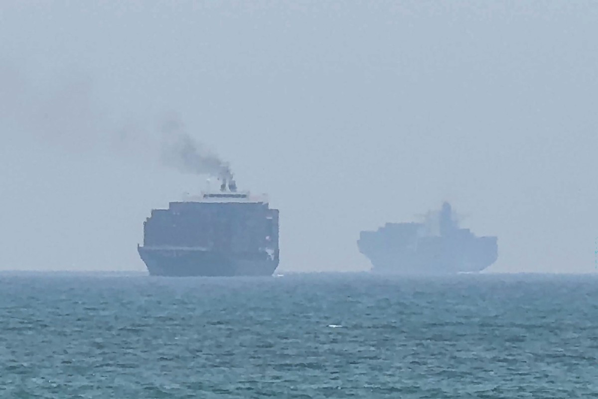 This frame grab taken from AFPTV video footage on July 12, 2026 shows cargo ships anchoring near the Strait of Hormuz off the eastern coast of the United Arab Emirates at Khor Fakkan. Tehran announced it was closing the Strait of Hormuz on July 12 and launched missiles and drones at its Gulf neighbors. 