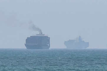 This frame grab taken from AFPTV video footage on July 12, 2026 shows cargo ships anchoring near the Strait of Hormuz off the eastern coast of the United Arab Emirates at Khor Fakkan. Tehran announced it was closing the Strait of Hormuz on July 12 and launched missiles and drones at its Gulf neighbors. 