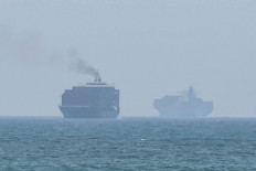 This frame grab taken from AFPTV video footage on July 12, 2026 shows cargo ships anchoring near the Strait of Hormuz off the eastern coast of the United Arab Emirates at Khor Fakkan. Tehran announced it was closing the Strait of Hormuz on July 12 and launched missiles and drones at its Gulf neighbors. 