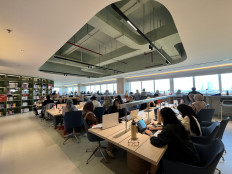 Visitors read, study and work on their laptops at the Nyi Ageng Serang Public Library in Rasuna Said, South Jakarta, on July 10, 2026. The library, which reopened on July 8, provides free access to thousands of books, workstations, reading areas and meeting rooms.