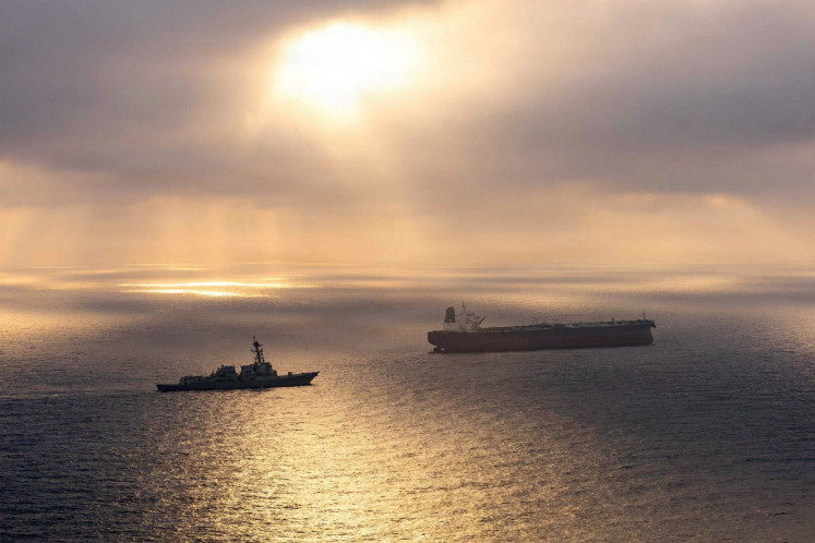 This US Navy handout photo released on May 8, 2026 by US Central Command Public Affairs, shows the Arleigh Burke-class guided-missile destroyer USS Rafael Peralta (DDG 115) implementing a maritime blockade against the Iran-flagged crude oil tanker vessel Herby while the latter was attempting to sail toward an Iranian port, on April 24, 2026.