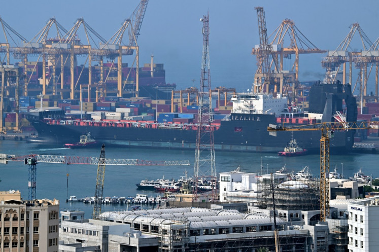 Ships are docked along a pier at the Khor Fakkan Container Terminal, the only natural deep-sea port in the region and one of the major container ports in Sharjah Emirate, along the Gulf of Oman on July 14, 2026.