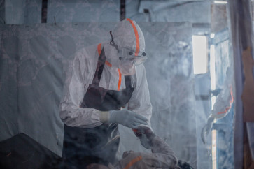 A doctor provides care to a patient with Ebola virus disease at the Rwampara Ebola Treatment Center in Bunia, Ituri, in the east of the Democratic Republic of Congo on July 13, 2026.