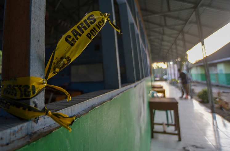 A janitor sweeps the floor after a homemade bomb blast at Madrasah Aliyah Negeri (MAN) 3 Padang in West Sumatra on July 14, 2026. 