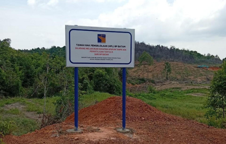A signpost stands onn July 15, 2026, before Pantai Melayu village on Rempang Island, Riau Islands, announcing that the Batam Free Trade Zone Authority (BP Batam) has the rights to manage (HPL) for the land, reportedly to be used as a Sekolah Rakyat. BP Batam's unilateral claim is heatedly challenged by villagers who claim ownership. 