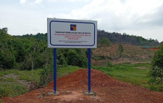 A signpost stands onn July 15, 2026, before Pantai Melayu village on Rempang Island, Riau Islands, announcing that the Batam Free Trade Zone Authority (BP Batam) has the rights to manage (HPL) for the land, reportedly to be used as a Sekolah Rakyat. BP Batam's unilateral claim is heatedly challenged by villagers who claim ownership. 