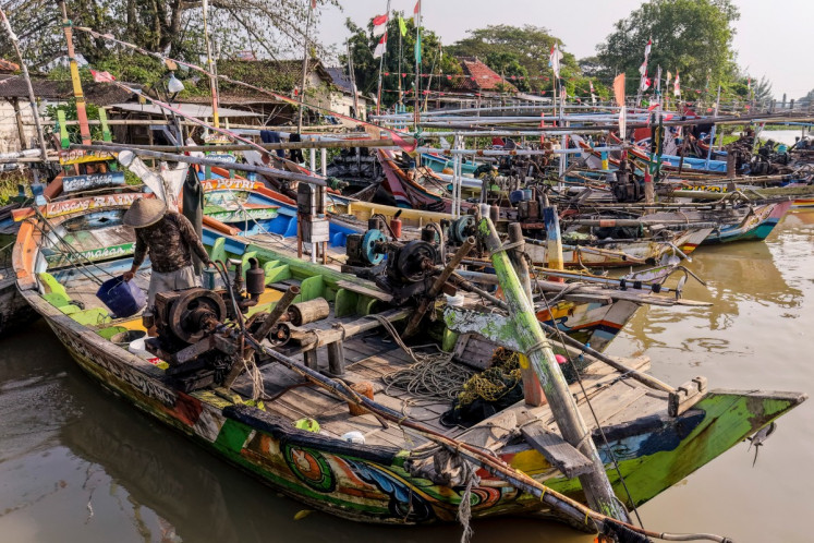 This aerial picture taken on June 10, 2026 shows traditional fishing boats moored at the traditional port in Bungko Lor hamlet in Cirebon, West Java. Indonesia is one of the top contributors of labor for the global fishing industry with several hundred thousand migrant workers, according to government figures. Many are recruited online and assigned to foreign-flagged ships without being properly informed about their rights, leaving them vulnerable to abuse, experts say.