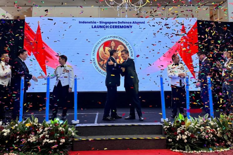 Singaporean Defense Minister Maj. Gen. (ret) Chan Chun Sing (center right) embraces his Indonesian counterpart Gen. (hon) Sjafrie Sjamsoeddin during the launch of the Indonesia-Singapore Defense Alumni (Persahan) in Jakarta on July 14, 2026. The launch was held in conjunction with the Singapore Armed Forces (SAF) Day reception. 