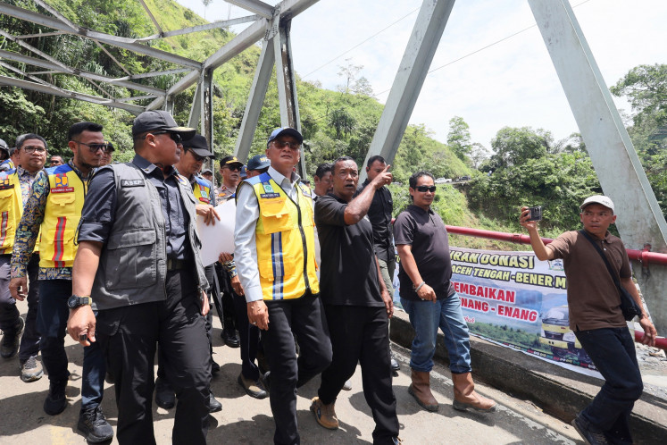 Public Works Minister Dody Hanggodo (center) inspects the newly-built Enang-Enang Bridge on July 8 at Arul Cincin village in Bener Meriah regency, Aceh. The minister ensured the safety of bridge that was built to reconnect the road between Takengon in Central Aceh and Bireuen regency that was destroyed during the 2025 floods and landslides in the province.