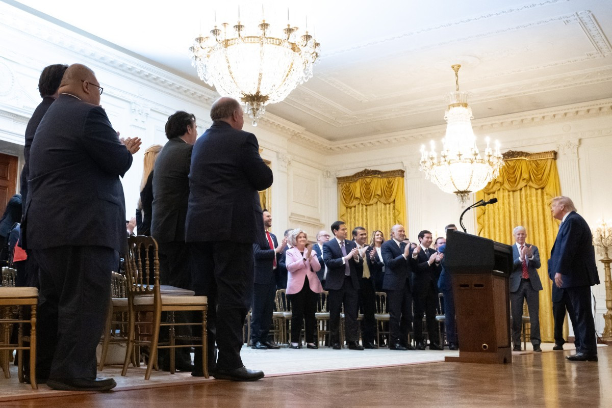 Attendees stand and applaud after US President Donald Trump delivered an address to the nation from the East Room of the White House in Washington, DC on July 16, 2026.