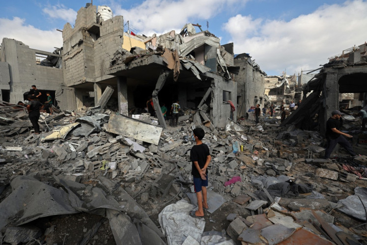 Palestinians inspect the site of an Israeli strike at the Bureij refugee camp in central Gaza Strip on July 16, 2026. Violence has continued in Gaza despite the ceasefire.