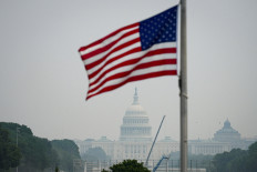 The United States Capitol and the US flag in smoky conditions due to the Canadian wildfires in Washington, D.C., the US, on July 17, 2026.
