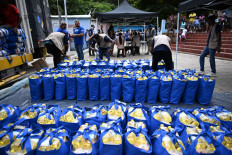 Workers unload donations from the World Food Programme (WFP) in Chichiriviche de la Costa, La Guaira state, Venezuela, on July 16, 2026, following the June 24 earthquakes. World Food Programme (WFP) trucks drive slowly along a narrow road between the sea and mountains after passing through Catia La Mar, where buildings were flattened by the double earthquake of June 24, as they head to supply the isolated and tourist village of Chichiriviche de la Costa in northern Venezuela, which sustained only slight damage but has been cut off from resources by the disaster that left nearly 5,000 dead.