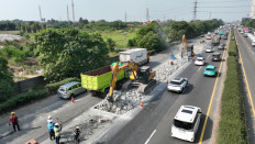 Heavy machinery is used to remove a section of road surface on the Jakarta-Tangerang toll road in Tangerang, Banten, in this undated handout photo.