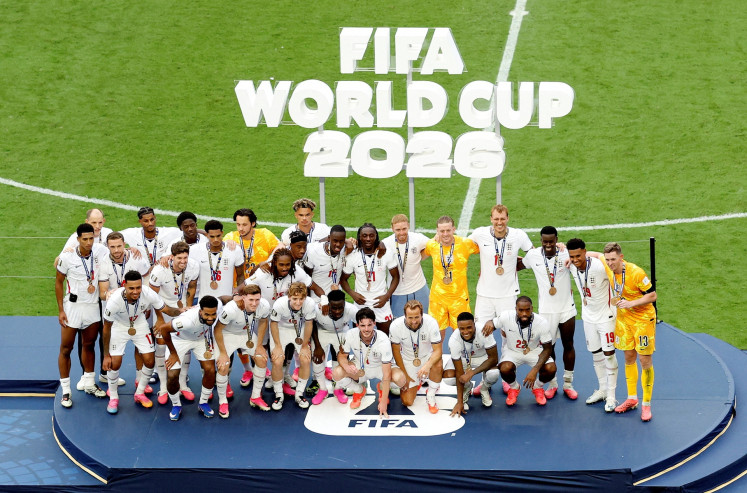 England manager Thomas Tuchel (back, second left) and England players wear their bronze medals as they pose for a picture on the podium during the ceremony after the World Cup 2026 third-place playoff match against France at the Miami Stadium in Florida, the United States, on July 18, 2026.