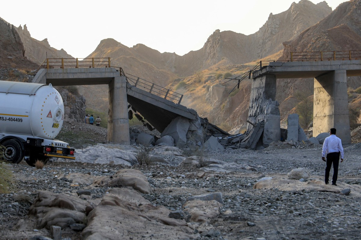 A heavily-damaged bridge which was hit by a US strike is pictured along the road connecting Roudan and Bandar Abbas in southern Iran on July 18, 2026. The United States hit Iran on July 17, with Tehran accusing US forces of striking civilian sites and drawing Iranian threats of reprisals on regional infrastructure. A battle over the strategic Strait of Hormuz has rekindled the war in the Middle East and the foes have traded fire for six days running.