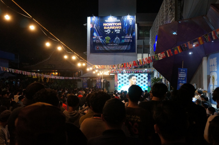 Hundreds of soccer fans watch the World Cup 2026 semifinal between England and Argentina on July 16 during a free public screening at the headquarters of state-owned broadcaster TVRI in Senayan, Central Jakarta. TVRI is the official broadcaster for the quadrennial soccer tournament in Indonesia.