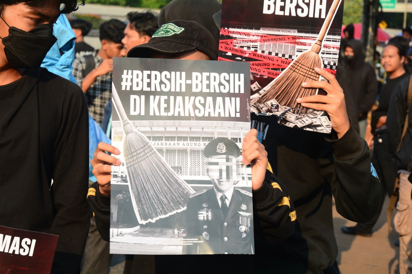 Protesters from a coalition of university students hold a banner reading &ldquo;Clean Up the Attorney General's Office&ldquo; during a demonstration outside the House of Representatives complex in Jakarta on July 10, 2026. The protesters called for an investigation into alleged corruption within the Attorney General's Office. 