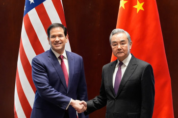 US Secretary of State Marco Rubio (left) shakes hands with China's Foreign Minister Wang Yi in Munich, on February 12, 2026, on the sidelines of the Munich Security Conference. 