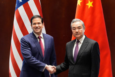 US Secretary of State Marco Rubio (left) shakes hands with China's Foreign Minister Wang Yi in Munich, on February 12, 2026, on the sidelines of the Munich Security Conference. 