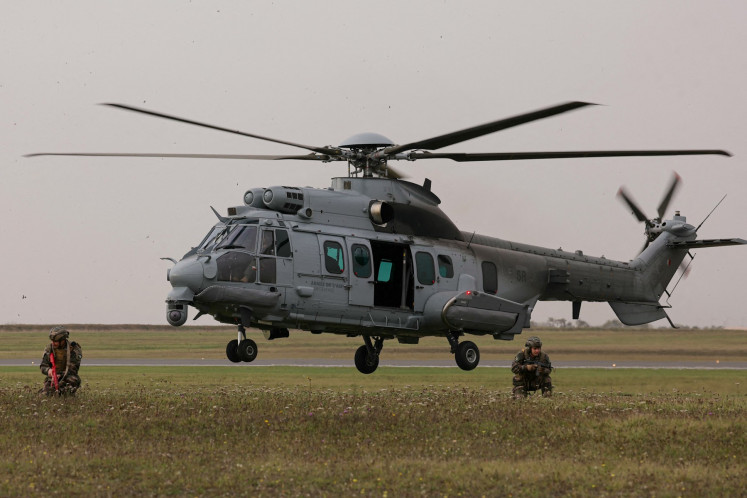 A French Air Force Airbus H225M Caracal Helicopter drops French Air Commandos as part of the French Air and Space Force military exercise Taranis (Tactical Airlift Rehearsal under Advanced Non-permissive and Intensive Scenarios), on the Orleans-Bricy air base, in Boulay-les-Barres on Nov. 14, 2025.