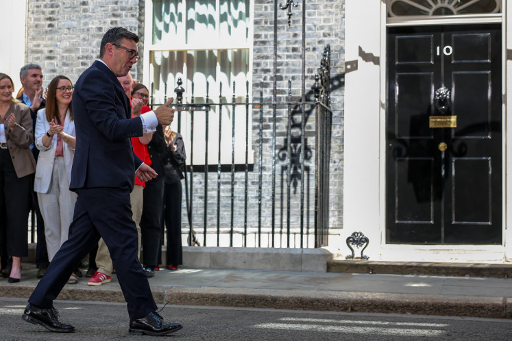 Britain's newly appointed Prime Minister Andy Burnham gives thumbs-up as he walks outside 10 Downing Street following his speech after taking office, in London, Britain, July 20, 2026.
