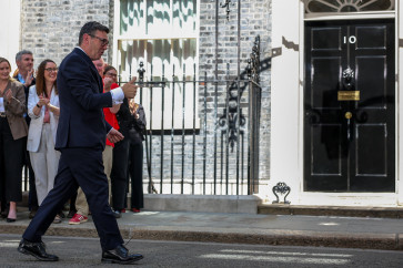 Britain's newly appointed Prime Minister Andy Burnham gives thumbs-up as he walks outside 10 Downing Street following his speech after taking office, in London, Britain, July 20, 2026.