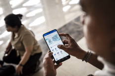 A man opens the Jateng Ngopeni Nglakoni application by the Central Java administration in his smartphone to access a free psychological consultation service in Semarang, Central Java, on July 3, 2026. The Central Java administration launched the app as an effort to early detect mental health issues among its residents, including children and students.