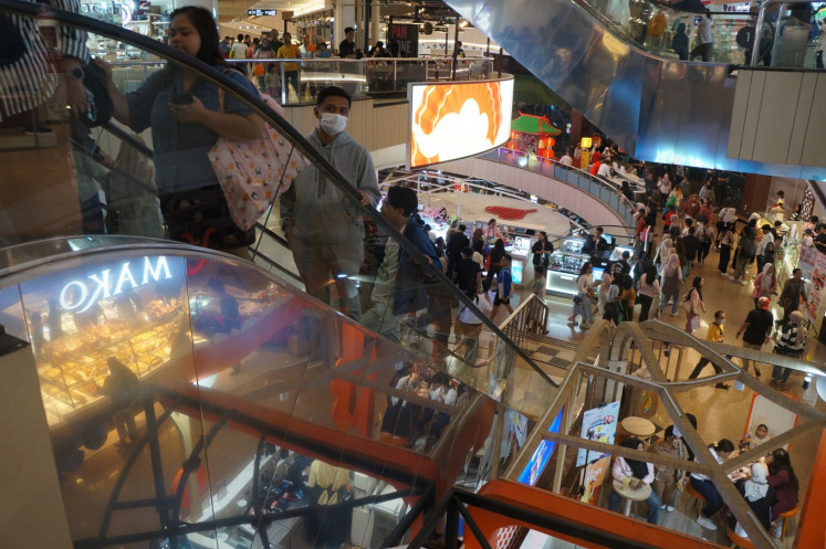 Visitors line up to take the escalator at Plaza Blok M on Feb. 1, 2025. Consumption remains the main driver of Indonesia's economic growth