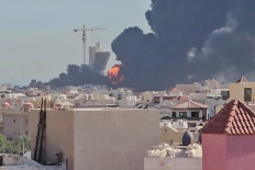 This screen grab taken from UGC video footage posted on social media on July 18, 2026, shows a plume of black smoke and flames billowing over the town of Mangaf, south of Kuwait City. Kuwait accused Iran on July 18 of targeting civilian sites and vital infrastructure in the country, after reporting attacks on an oil facility and a power and water plant. 