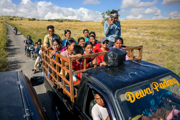 This photo taken on June 23, 2026 shows villagers riding a truck along a road at Tanggedu village in East Sumba, East Nusa Tenggara.
