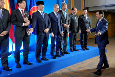 United States Secretary of State Marco Rubio (right) gestures as he arrives for a group photo session, while (from left to right) Cambodia's Foreign Minister Prak Sokhonn, Brunei's Foreign Minister Prince Abdul Maseen Bolkiah, Foreign Minister Sugiono, Laos Foreign Minister Thongsavanh Phomvihane, Malaysian Foreign Minister Mohamad Hasan, Myanmar's Permanent Secretary of the Ministry of Foreign Affairs Hau Khan Sum and ASEAN Secretary-General Kao Kim Hourn react during the ASEAN Post Ministerial Conference on July 22 with the United States on the sidelines of the ASEAN Foreign Ministers' Meeting (AMM) in Manila, the Philippines.