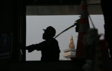 The National Monument (Monas) is framed beyond the silhouette of a construction worker inside the underground tunnel of the Jakarta MRT Phase 2A Contract Package 201 project in Jakarta on July 22, 2026.