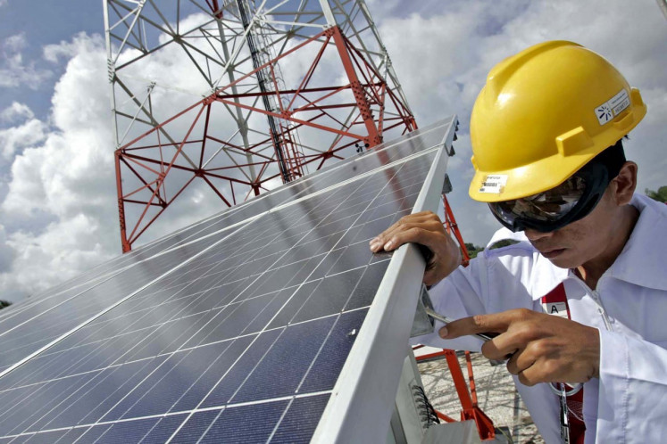 A technician performs maintenance work on a solar power system in Minas, Riau. (Photo:/R. Berto Wedhatama)