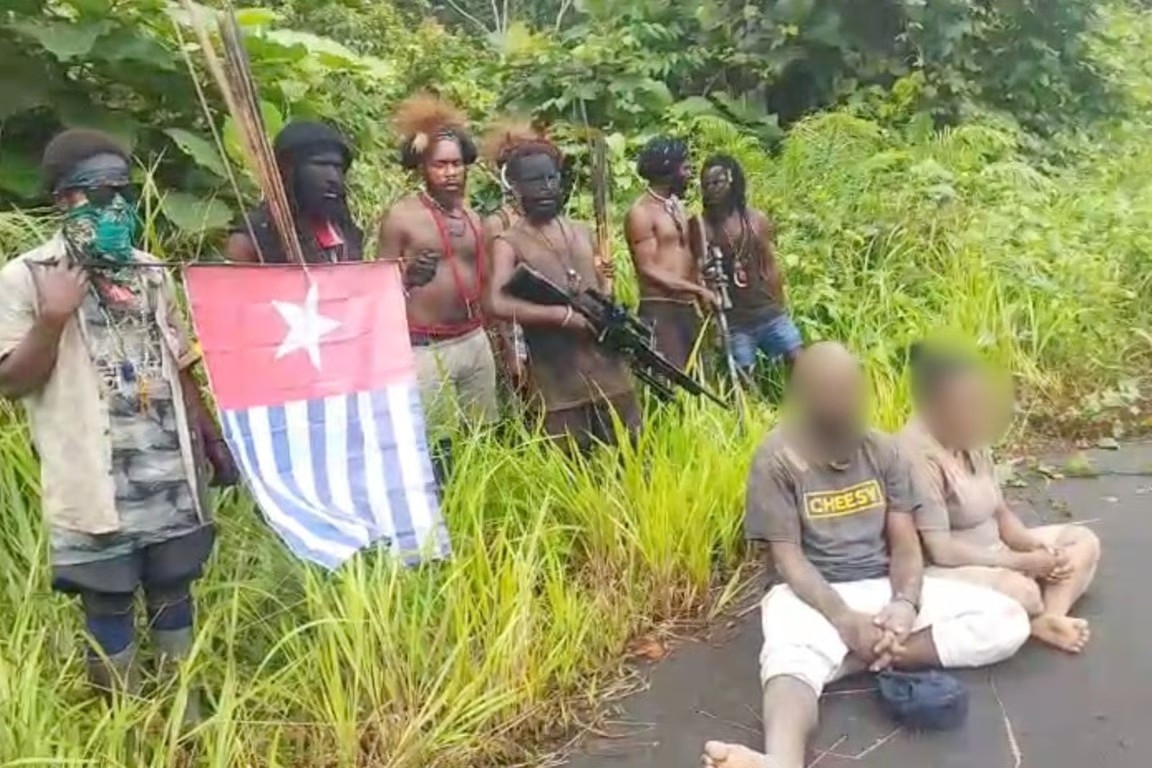 A group of rebels from the West Papua National Liberation Army-Papua Freedom Organization (TPNPB-OPM) gather on Tuesday behind a couple, identified as Kumis Kogoya and Seli Wenda, before their execution-style killing along Trans Papua Highway in Seradala District, Yahukimo regency, Papua Highlands. The rebels killed a total of three civilians in execution-style shootings, accusing the victims of being intelligence agents for the Indonesian government. 