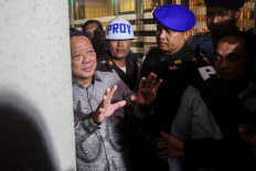 Former deputy attorney general for special crimes Febrie Adriansyah (left) speaks to reporters after questioning at the Attorney General's Office in Jakarta on July 24, 2026. 