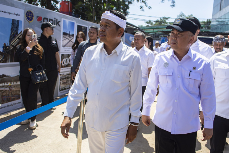 West Java Governor Dedi Mulyadi (left) walks with Transportation Minister Dudy Purwagandhi (right) ahead of the groundbreaking of mass rapid transit station as part of bus rapid transit infrastructure connecting the Greater Bandung area on July 22 at the Leuwipanjang bus terminal in Bandung, West Java.