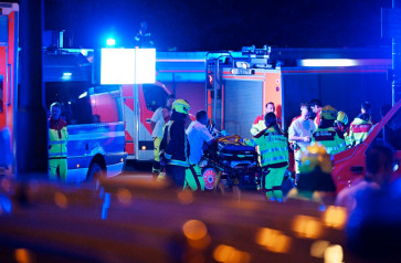 Emergency personnel and police work near the scene where one person was killed and around 15 injured after a car is believed to have hit the crowd on the outskirts of the Christopher Street Day (CSD) parade in Berlin, on July 25, 2026.