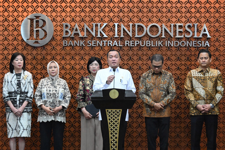 State Secretary Prasetyo Hadi, third right, accompanied by Bank Indonesia (BI) deputy governors, speaks on July 27 during a press conference on the resignation of BI Gov. Perry Warjiyo in Jakarta. 