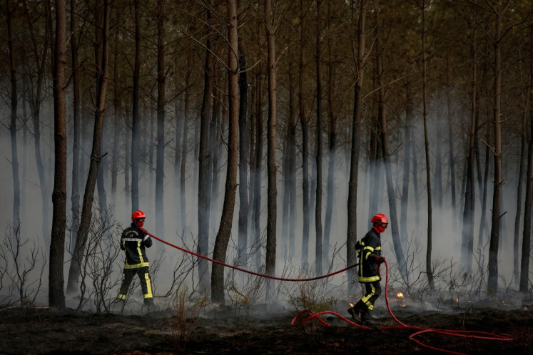 Firefighters battle a forest fire in Saint-Jean-d'Illac, some 30km from Bordeaux, on July 26, 2026 as a wildfire has been ravaging the forest north of the Arcachon Basin (Gironde).