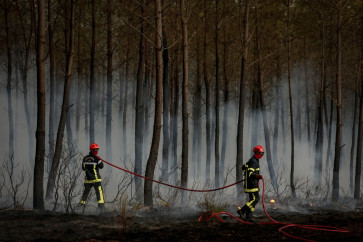 Firefighters battle a forest fire in Saint-Jean-d'Illac, some 30km from Bordeaux, on July 26, 2026 as a wildfire has been ravaging the forest north of the Arcachon Basin (Gironde).