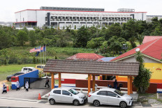 Pupils leave a school with a data center in the background, in Johor state, which has become Southeast Asia's fastest-growing data center hub, at Gelang Patah, Malaysia May 8, 2026. 