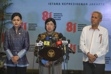 Acting Bank Indonesia governor Destry Damayanti (center), Financial Services Authority (OJK) chair Friderica Widyasari Dewi (left) and Indonesia Deposit Insurance Corporation (LPS) chair Anggito Abimanyu speak to reporters after attending a Financial System Stability Committee (KSSK) meeting with President Prabowo Subianto at the Presidential Palace in Jakarta on July 27, 2026.