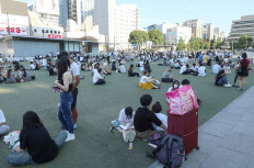 People wait in a park after evacuating buildings following a strong earthquake in Kumamoto City, Chuo Ward on July 28, 2026. A major earthquake collapsed buildings and sparked fires in Japan's southwest, Prime Minister Sanae Takaichi said, with broadcaster NHK saying that at least 50 people were taken to hospital.