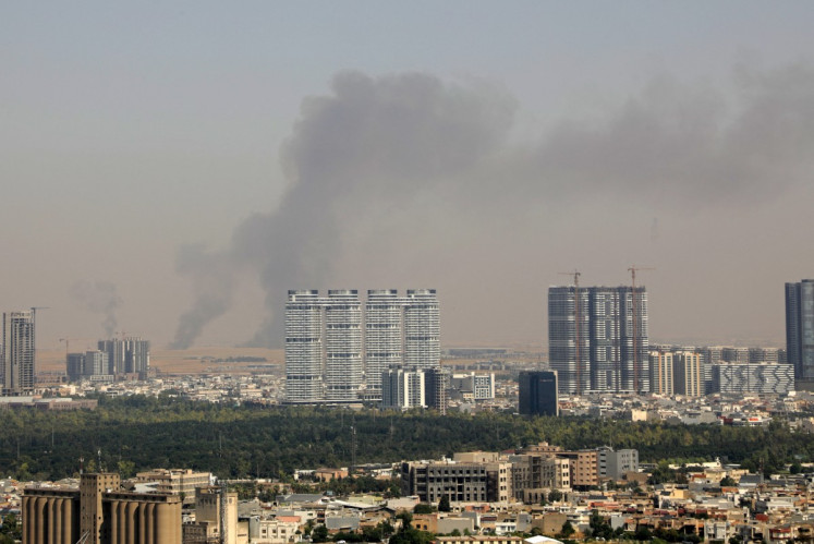 Smoke rises after explosions were heard and air defenses activated near the airport in Erbil, on July 24, 2026. Several blasts sounded on July 24 near Erbil airport, which hosts US-led coalition troops in Iraq's autonomous Kurdistan region.