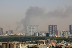 Smoke rises after explosions were heard and air defenses activated near the airport in Erbil, on July 24, 2026. Several blasts sounded on July 24 near Erbil airport, which hosts US-led coalition troops in Iraq's autonomous Kurdistan region.